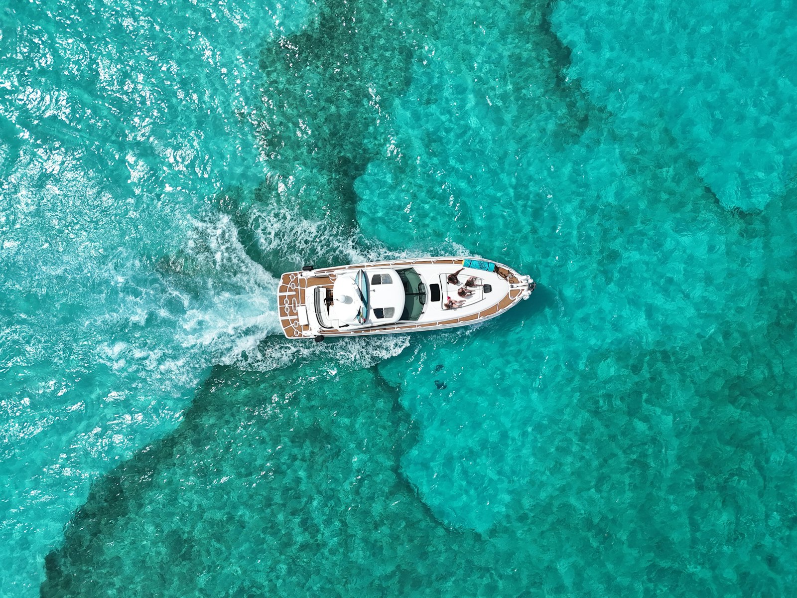 Boot fährt durch kristallklares blaues Wasser